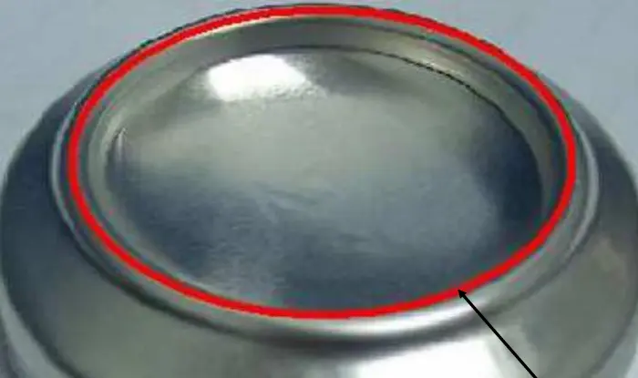 How are aluminum cans made? 18 Close-up of domed aluminum can bottom for pressure resistance