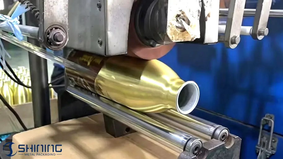 Heat transfer process applying pre-printed film onto aluminum bottle surface using heat and pressure