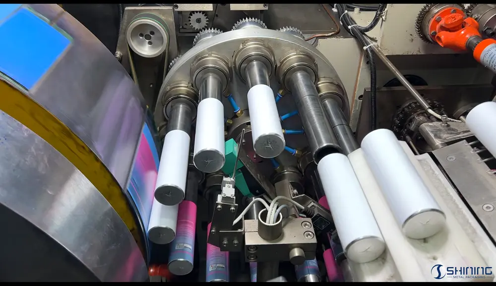 High-speed offset printing machine applying multi-color decoration onto aluminum bottles using rubber blanket cylinders