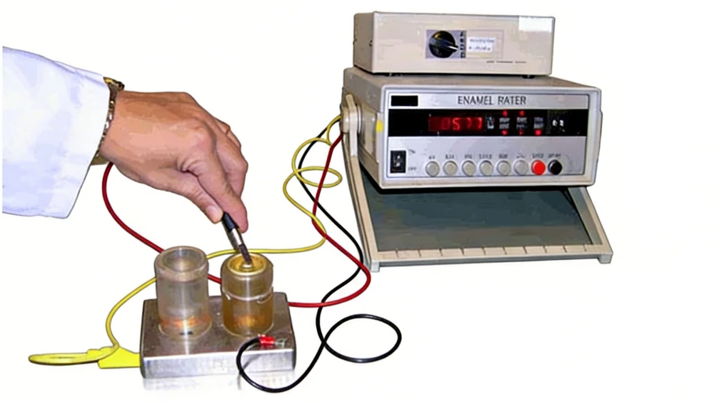 An operator using a manual enamel rater probe to measure the electrical current and coating continuity of a valve mounting cup.